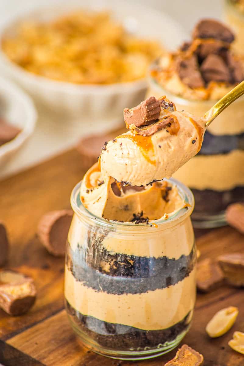 a spoonful of peanut butter mousse topped with peanut butter and a mini Reese's cup.
