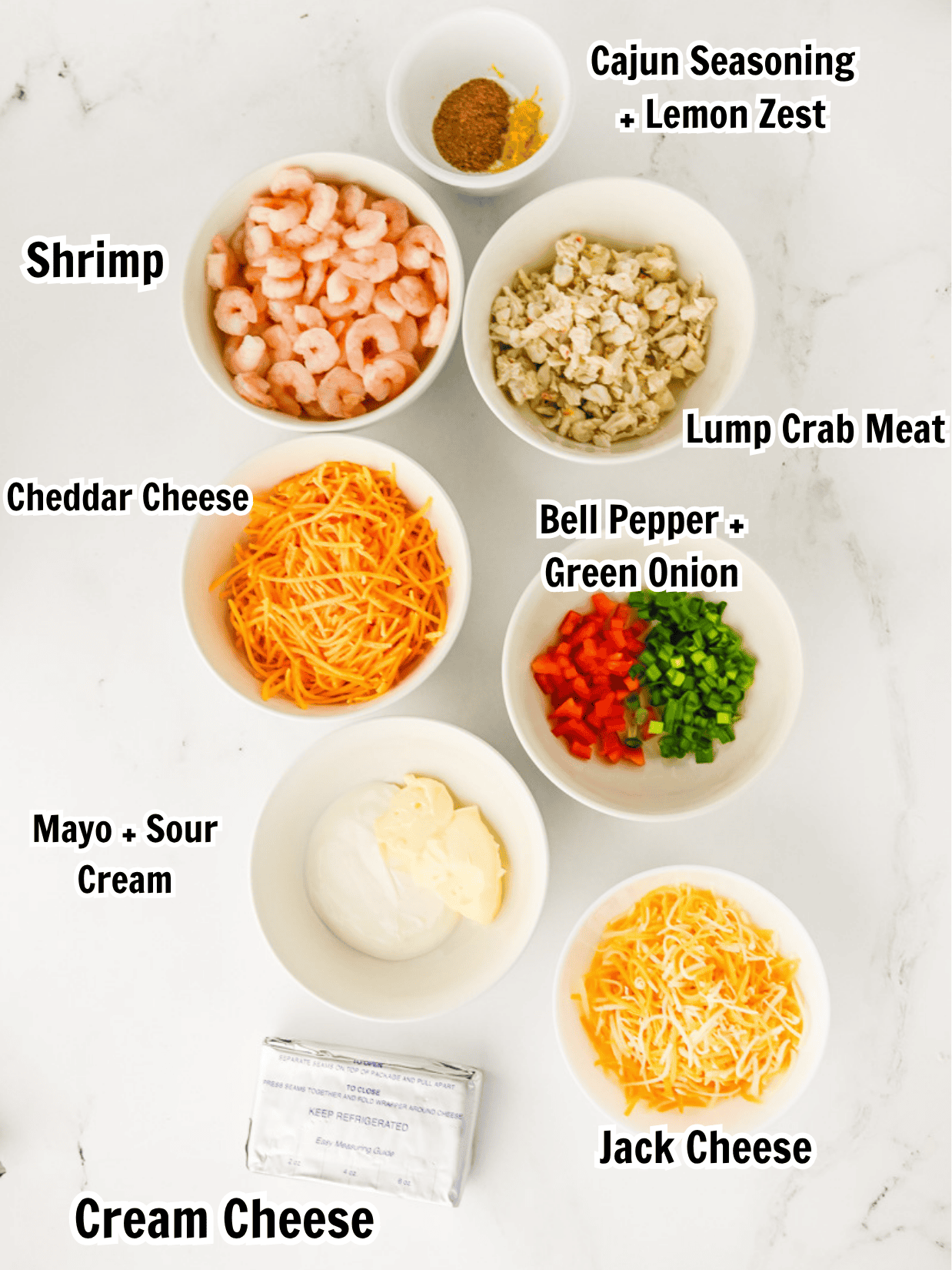 ingredients including shrimp, lump crab meat, sour cream, cream cheese, mayonnaise. Cajun seasoning, and lemon zest.