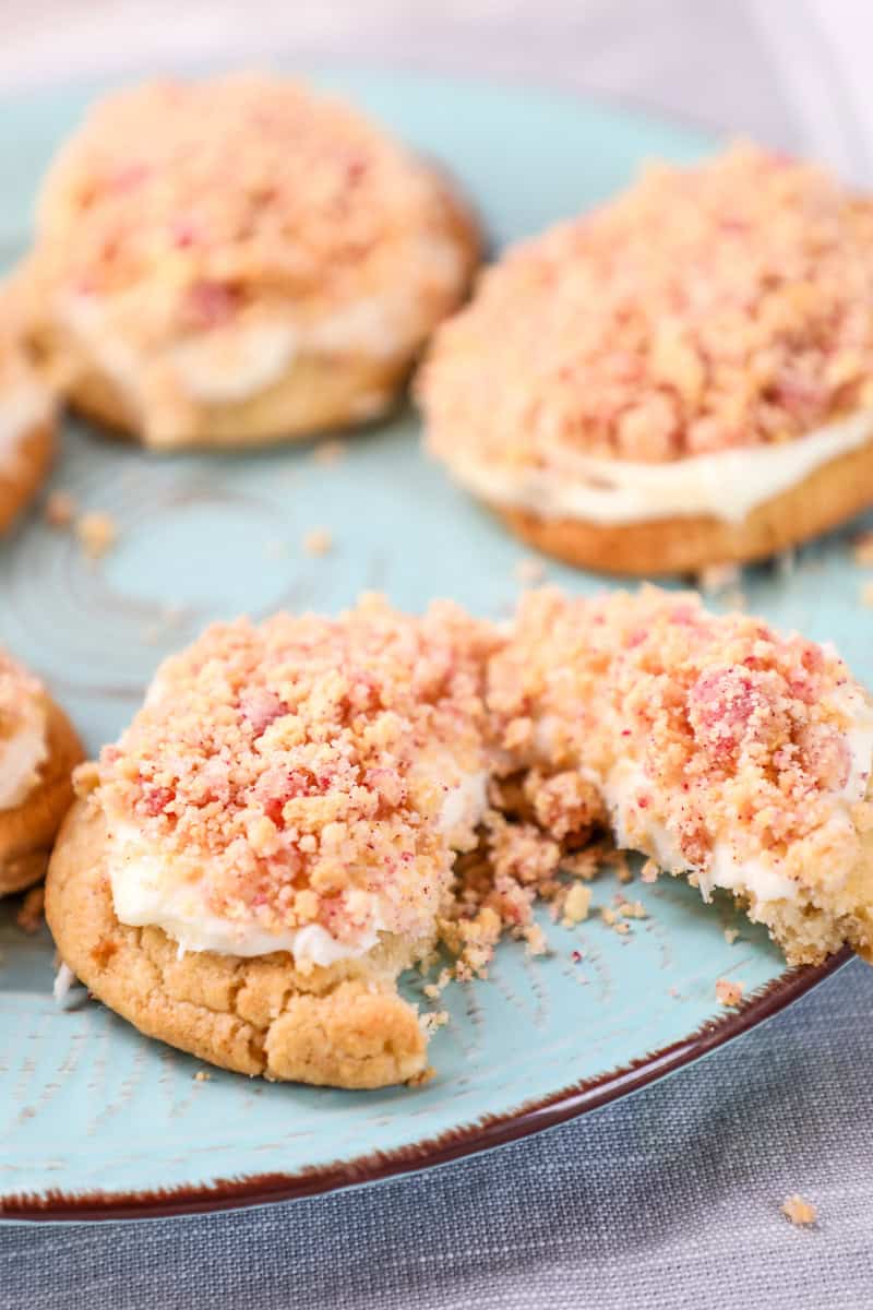 a strawberry shortcake cookie topped with buttercream frosting and an oreo and jello crunch topping.