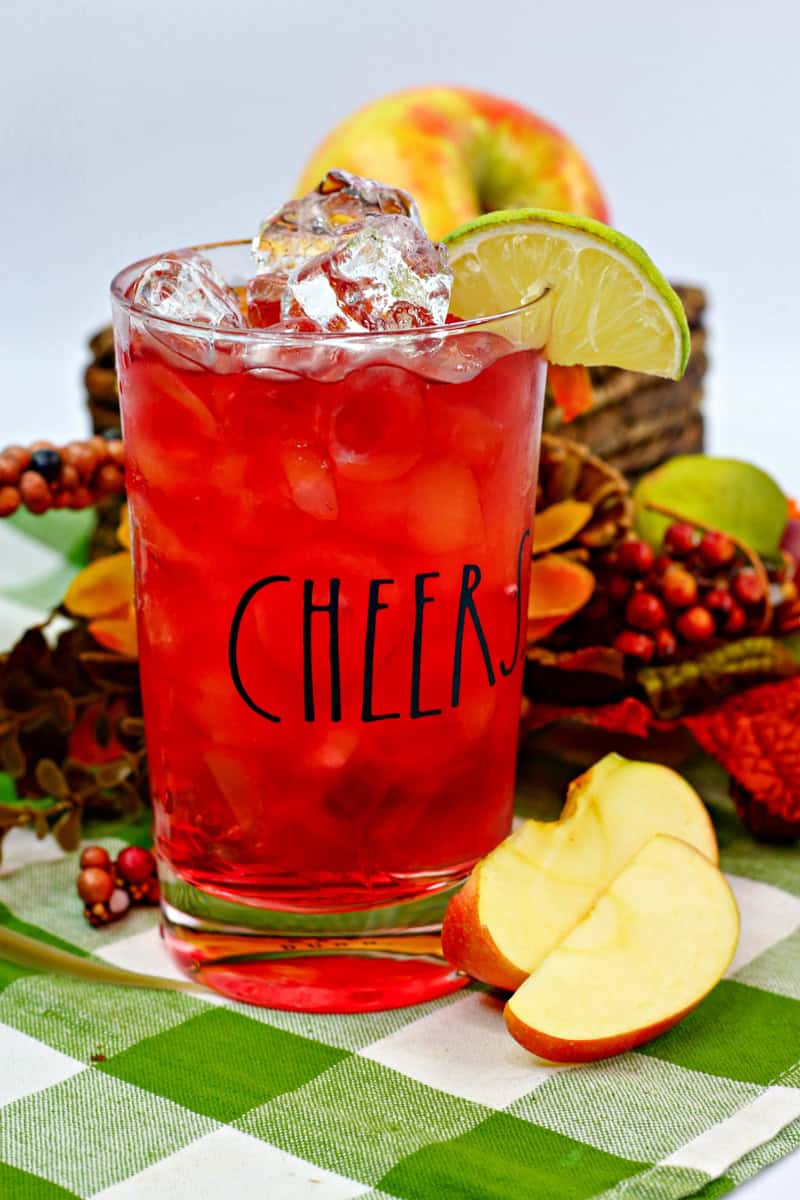 a Washington apple drink in a Cheers glass with ice and a slice of lime.