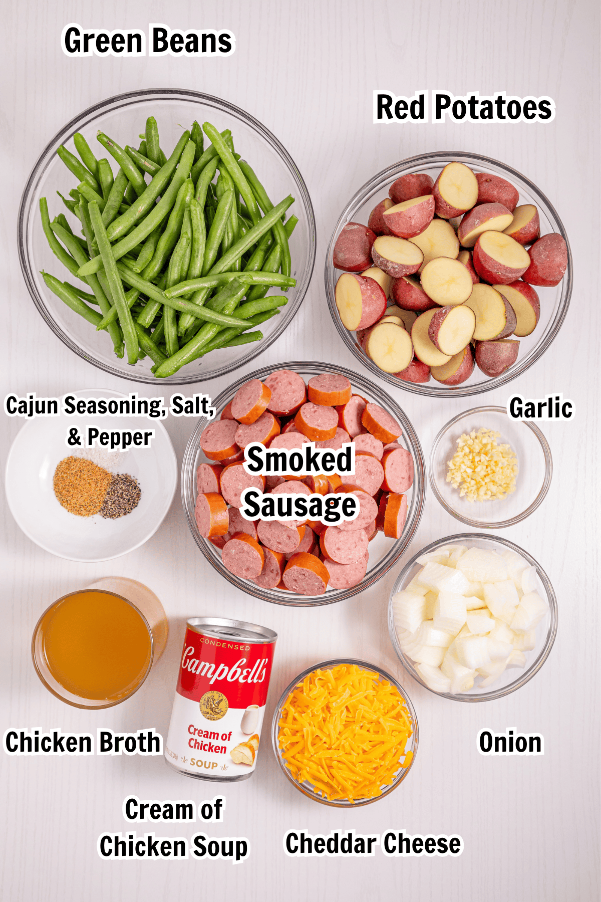 ingredients including smoked sausage, red potatoes, green beans, onion, garlic, Cajun seasoning, and cheese.