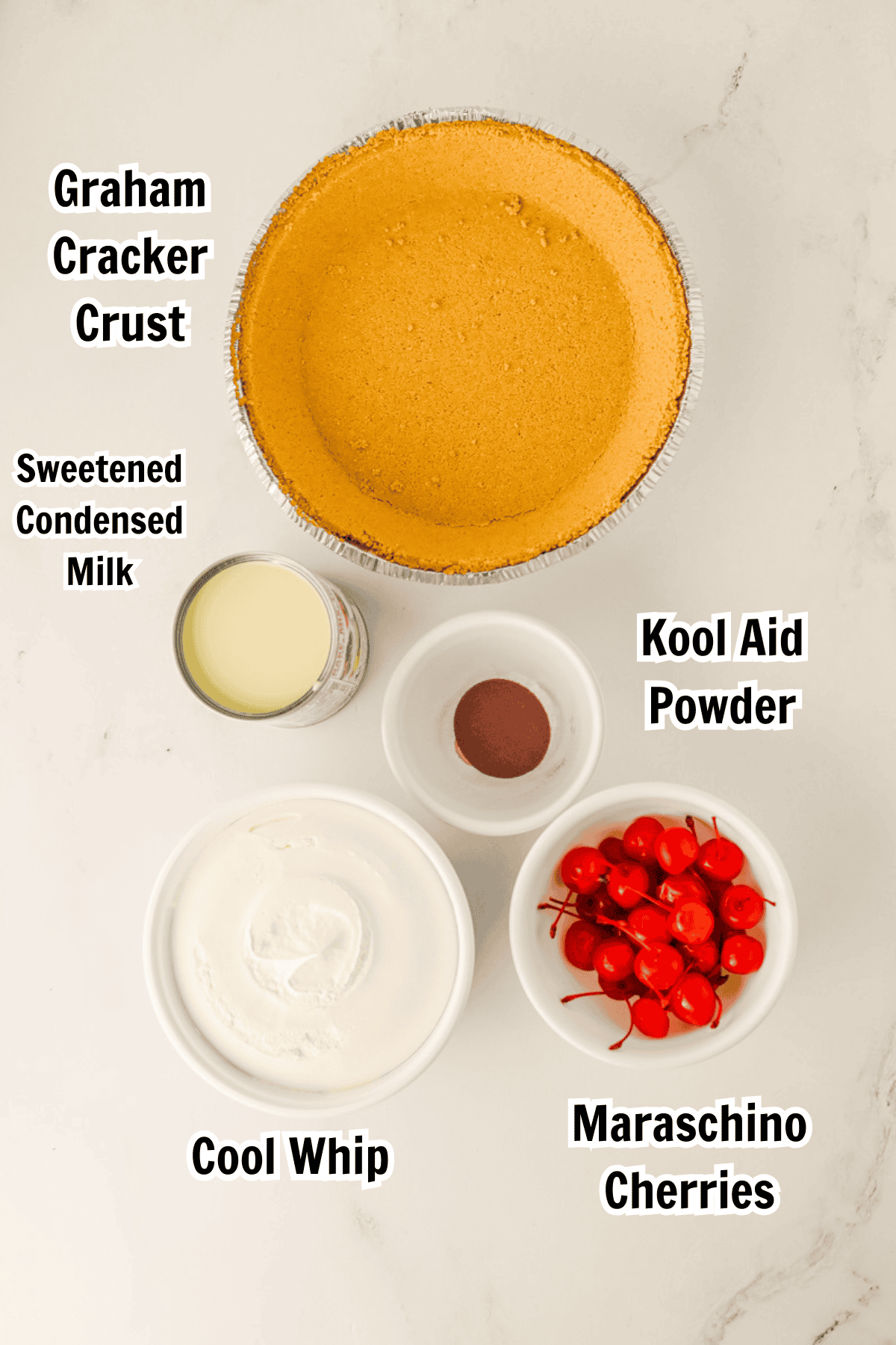 ingredients including a graham cracker crust, sweetened condensed milk, cherry Kool Aid, Cool Whip, and maraschino cherries. 