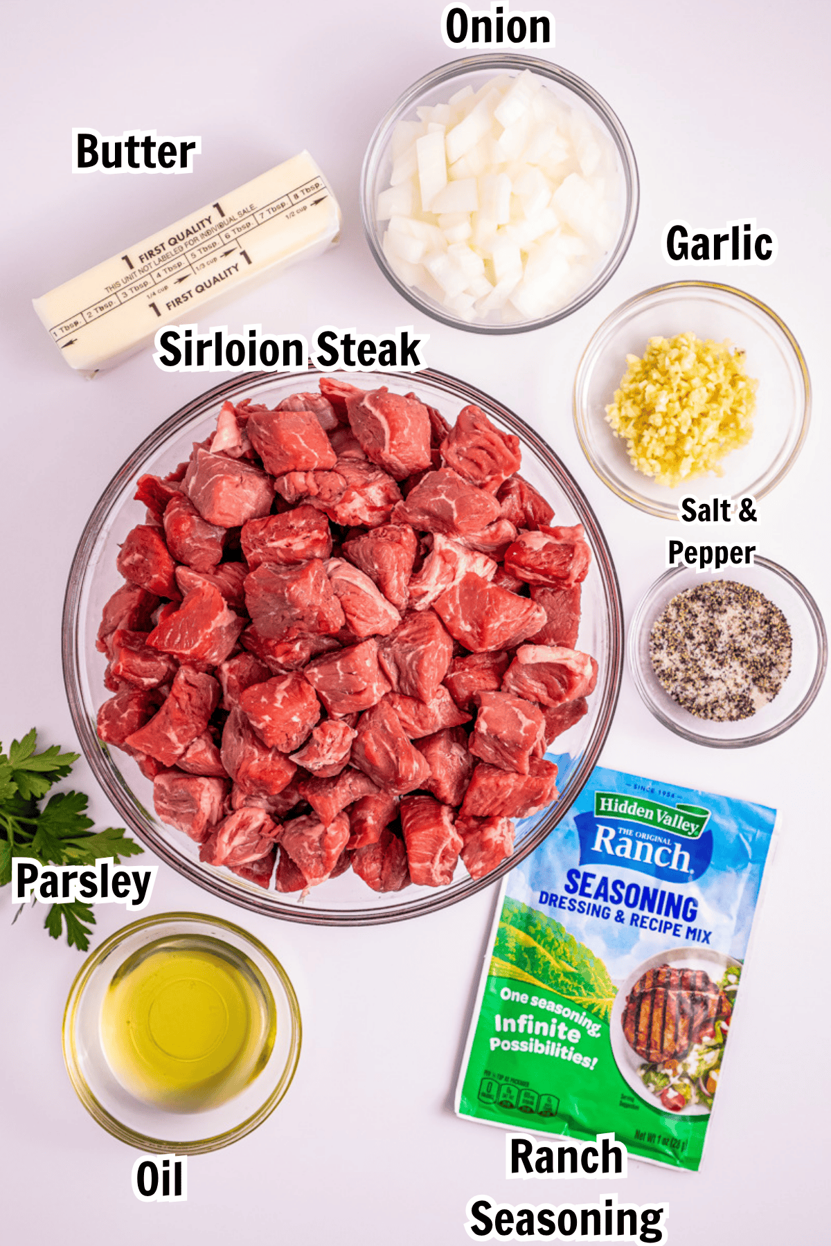 ingredients including steak, onion, garlic, butter, oil, ranch seasoning, salt, and pepper.