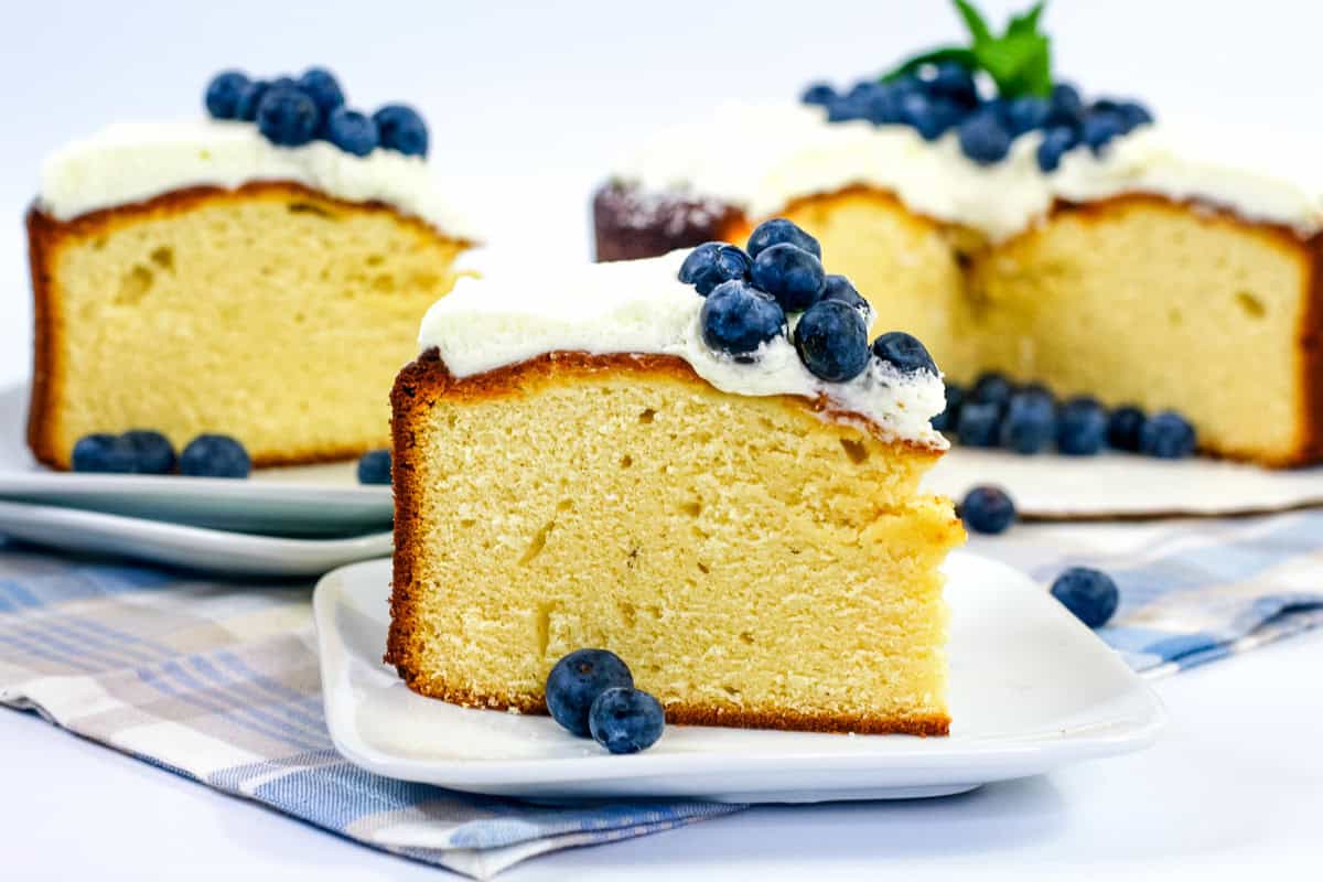 sweetened condensed milk cake topped with cool whip and blueberries.