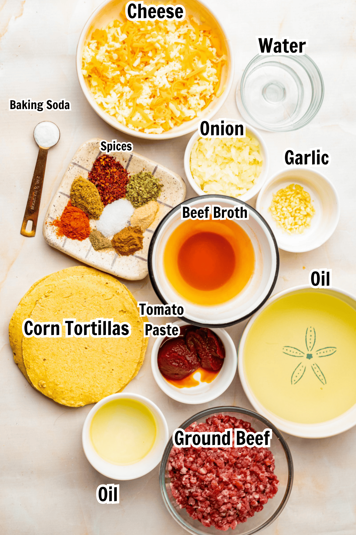 ingredients including ground beef, corn tortillas, beef broth, oil, onion, spices, tomato paste, and cheese.